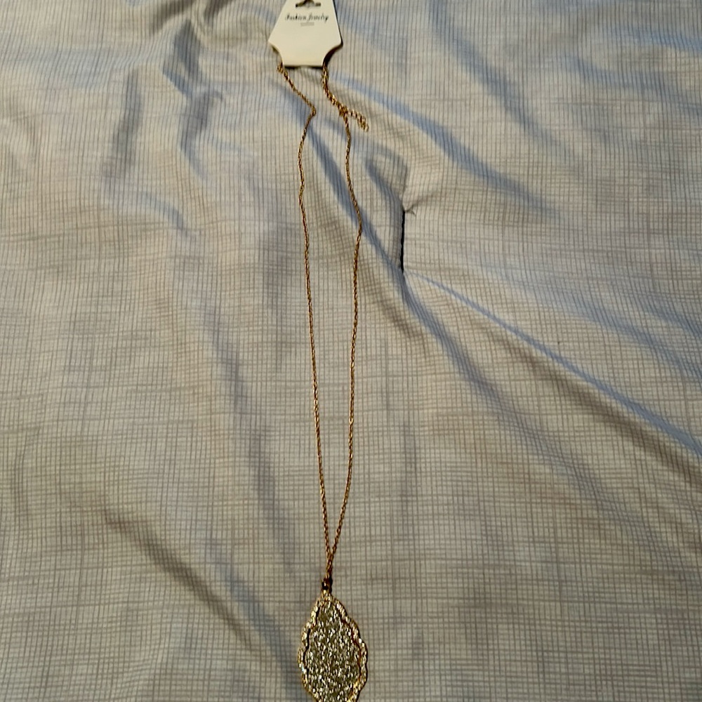 Long gold necklace with the tassel and sparkles.  Brand new.